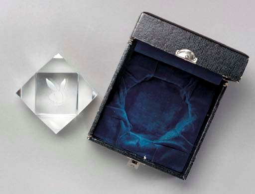 HEFNER, Hugh M. Playboy crystal paperweight which sat on his desk in Chicago in the 1960s, with rabbit head logo etched at top, in custom box. Diameter 3 in.