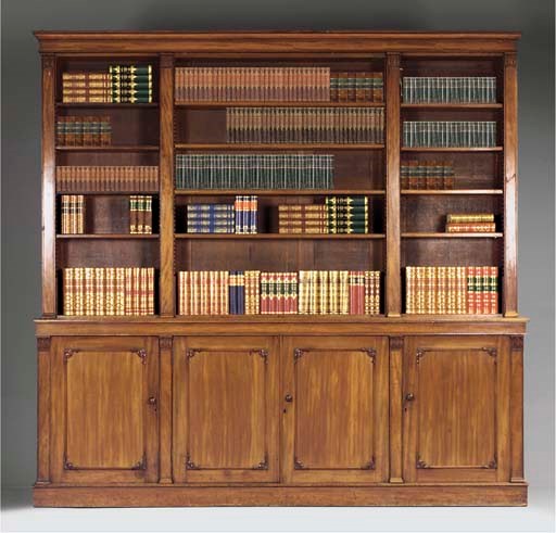 An early Victorian carved mahogany breakfront bookcase