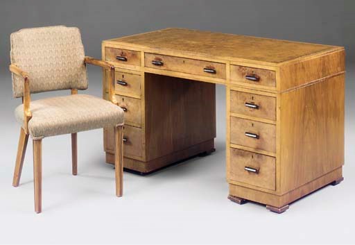 An Art Deco walnut pedestal desk and an accompanying armchair