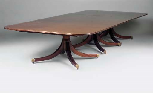 A MAHOGANY TRIPLE PEDESTAL DINING TABLE