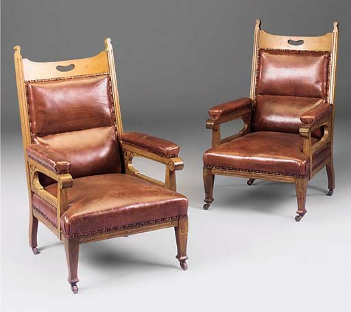 A PAIR OF OAK AND RED LEATHER UPHOLSTERED EASY ARMCHAIRS