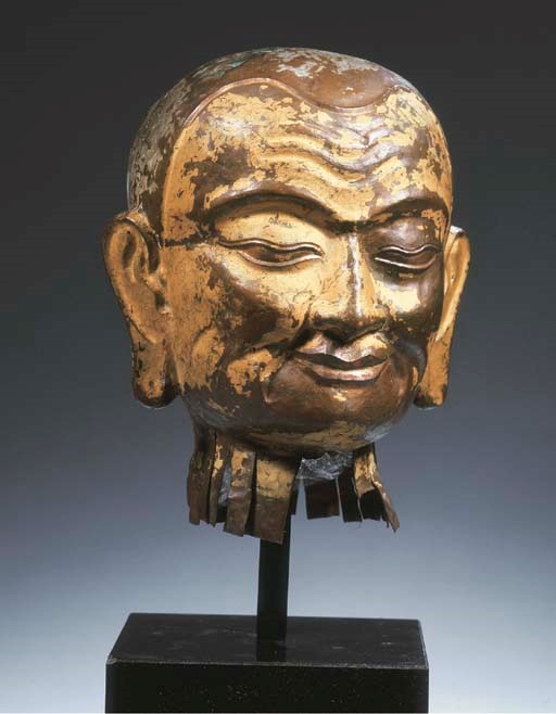 a tibetan repousee copper male head