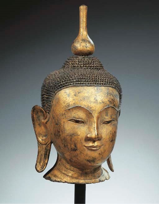 a burmese, shan period, gilt and black-lacquered wood head of buddha sakyamuni