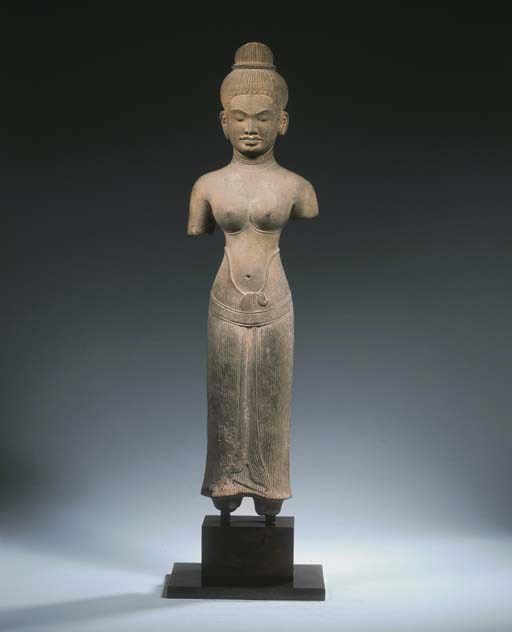 an important khmer, baphuon style, sandstone figure of probably durga