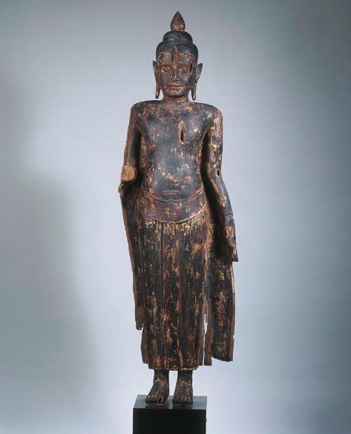 a post-angkor black lacquered wood figure of buddha sakyamuni