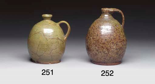 A GLAZED REDWARE JUG