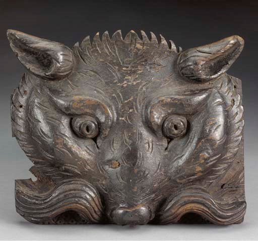 A CARVED AND PAINTED WALNUT FOX HEAD