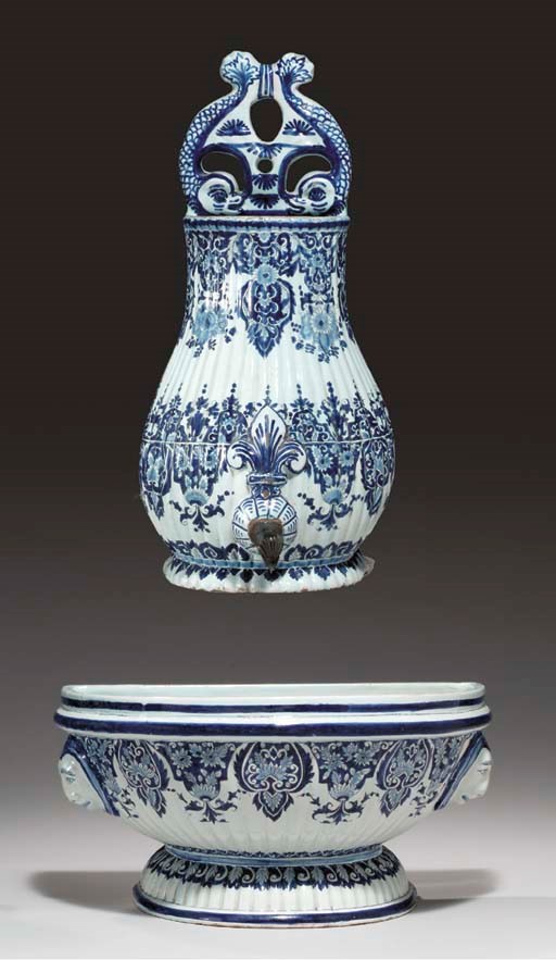 A ROUEN STYLE FAIENCE RIBBED WALL CISTERN AND BASIN