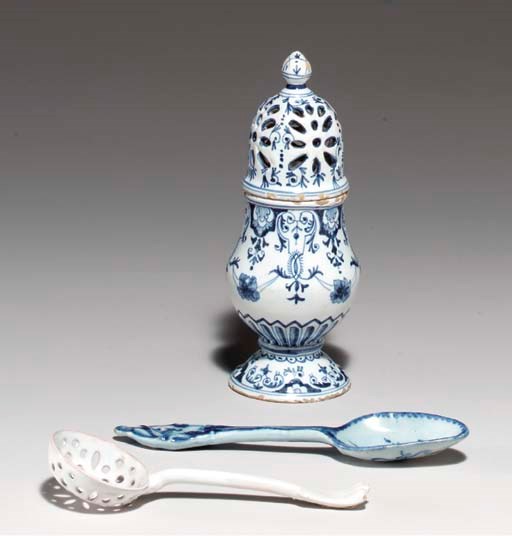 A FRENCH FAIENCE BLUE AND WHITE CASTER AND A WHITE SIFTER SPOON