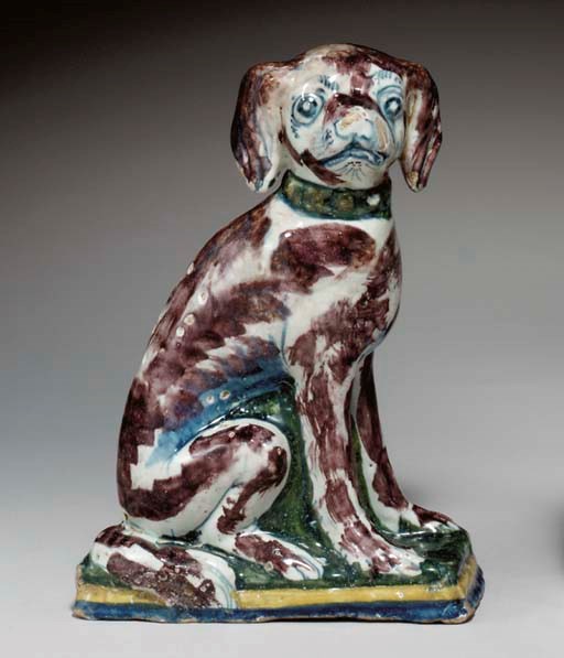 A BRUSSELS FAYENCE MODEL OF A SEATED HOUND