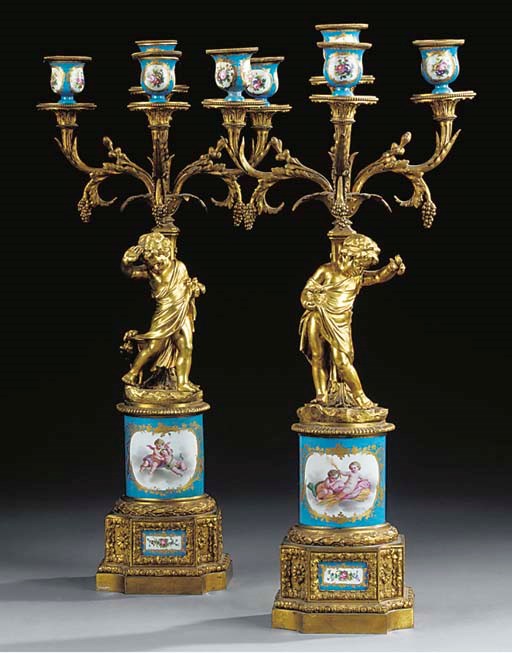 A PAIR OF FRENCH GILT BRONZE AND PORCELAIN FOUR-LIGHT CANDELABRA