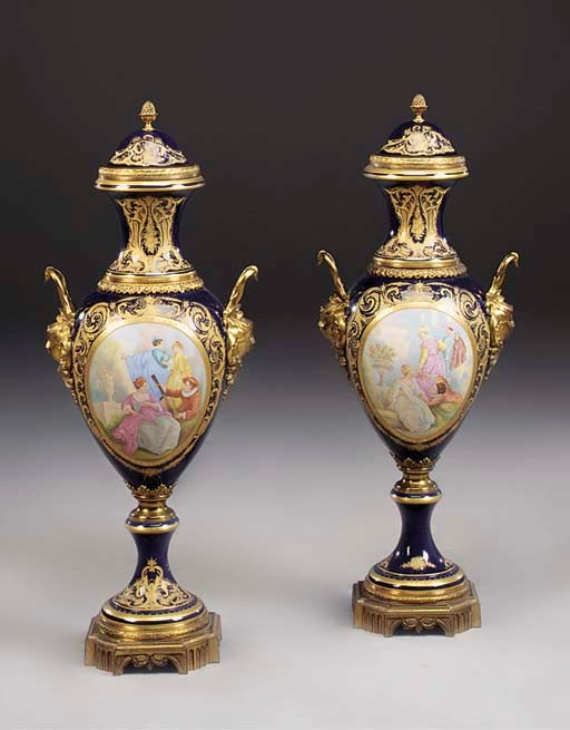 A PAIR OF FRENCH PORCELAIN AND GILT BRONZE VASES AND COVERS