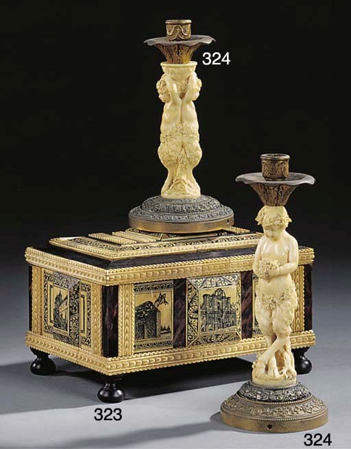 TWO CARVED IVORY AND GILT METAL CANDLESTICKS
