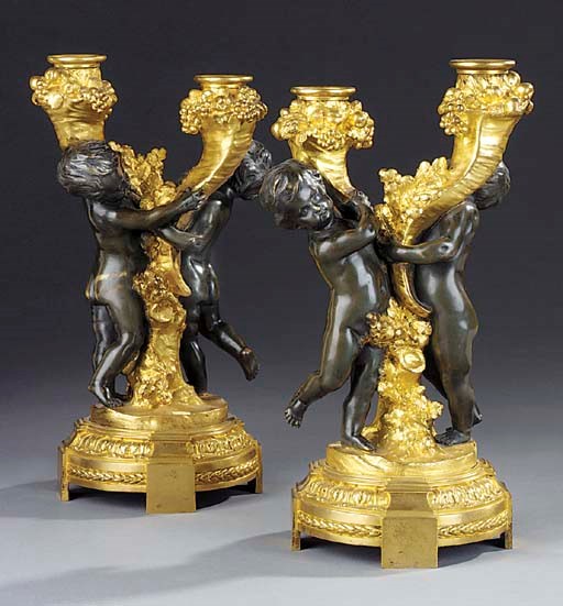 A PAIR OF FRENCH GILT AND PATINATED BRONZE TWIN-LIGHT FIGURAL CANDELABRA