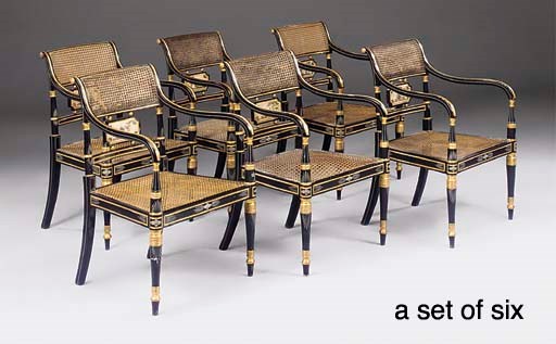 A SET OF SIX REGENCY LATER EBONISED AND GILT DECORATED ARMCHAIRS