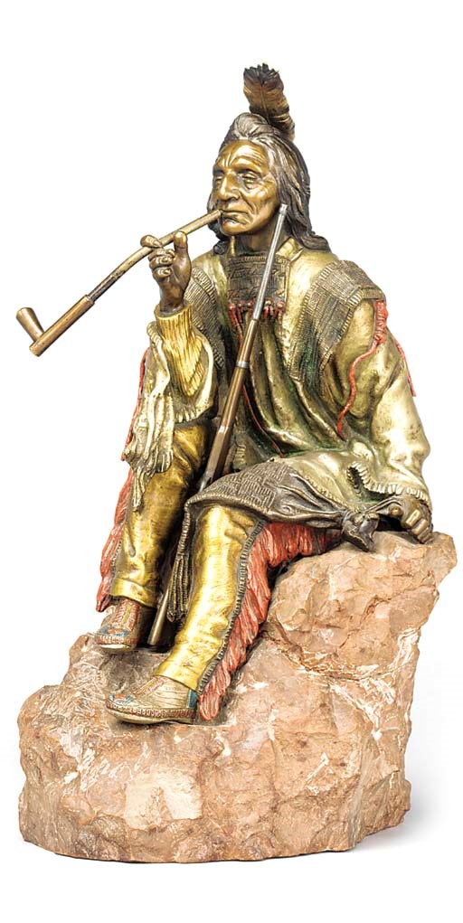 A COLD PAINTED BRONZE FIGURE OF A SEATED INDIAN