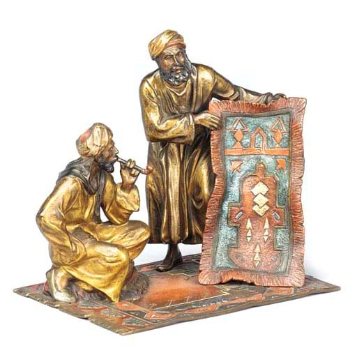 AN AUSTRIAN COLD PAINTED BRONZE OF A CARPET SELLER