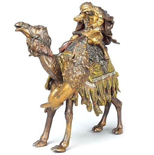 AN AUSTRIAN COLD PAINTED BRONZE GROUP OF A LION ATTACKING A CAMEL