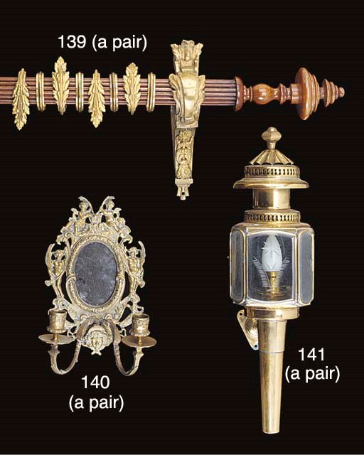 A pair of gilt bronze mounted mahogany curtain poles