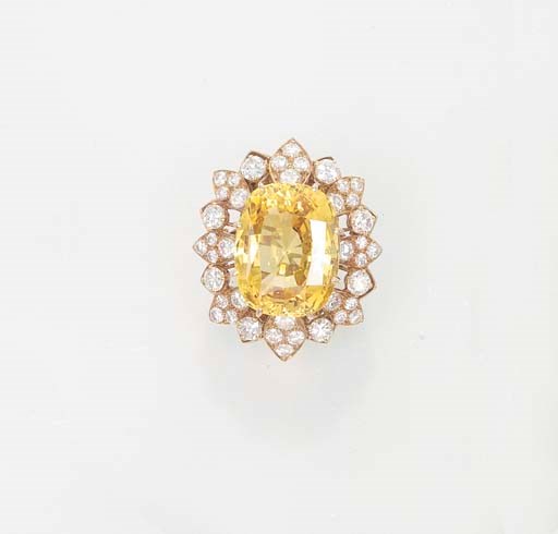 A YELLOW SAPPHIRE AND DIAMOND CLUSTER RING