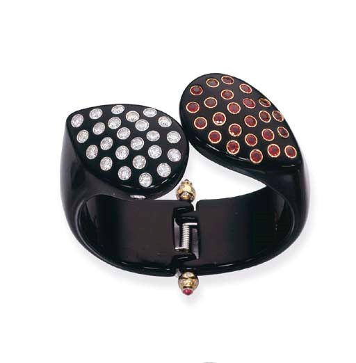 A BLACK BAKELITE, DIAMOND AND RUBY BANGLE