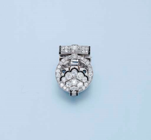 A DIAMOND AND ONYX CLIP BROOCH, BY CARTIER