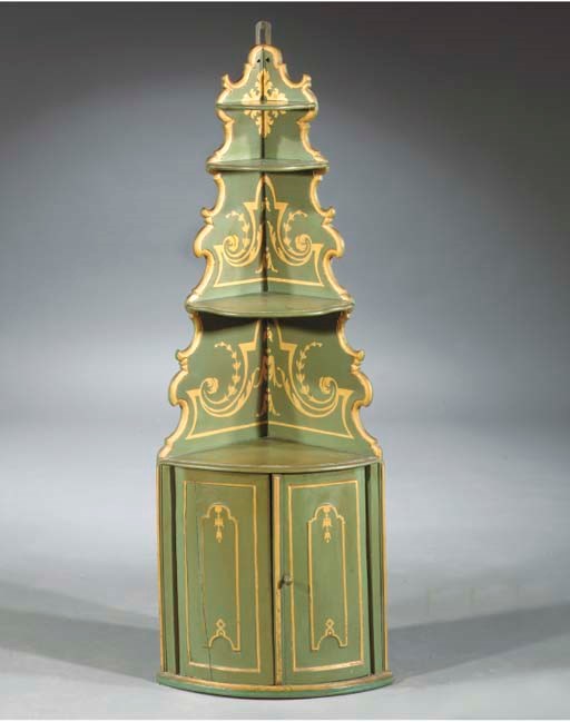 A Dutch green-painted and parcel-gilt hanging corner cupboard