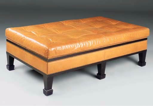 AN EBONISED AND TAN LEATHER LARGE STOOL