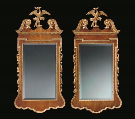 A GEORGE II WALNUT AND PARCEL-GILT MIRROR