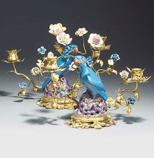 A PAIR OF GILT METAL AND PORCELAIN TWIN LIGHT CANDELABRA