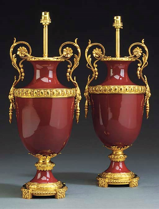 A PAIR OF GILT BRONZE AND ROUGE PORCELAIN VASES