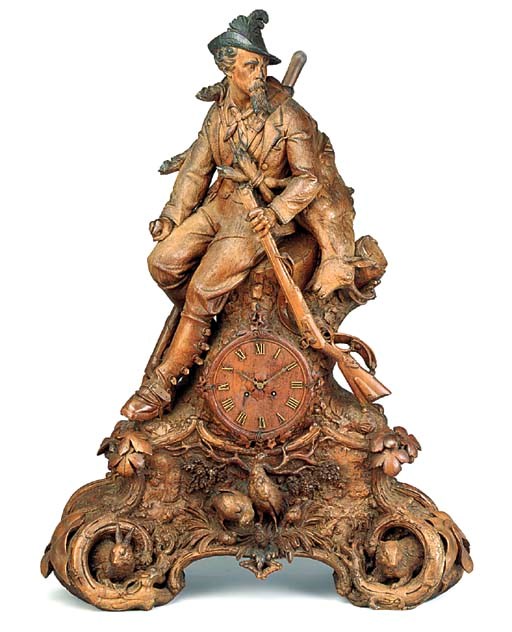 A SWISS 'BLACK FOREST' CARVED WOOD MANTEL CLOCK