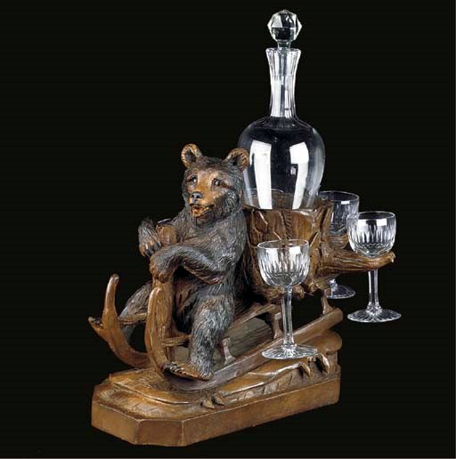 A SWISS 'BLACK FOREST' CARVED WOOD BEAR DECANTER STAND