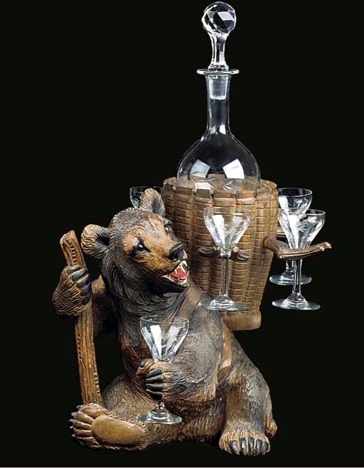 A SWISS 'BLACK FOREST' CARVED WOOD BEAR DECANTER STAND