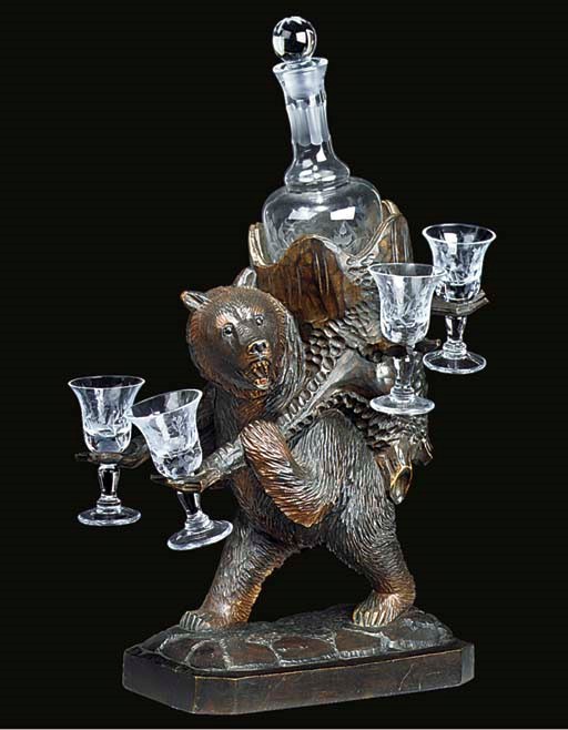 A SWISS 'BLACK FOREST' CARVED WOOD BEAR DECANTER STAND