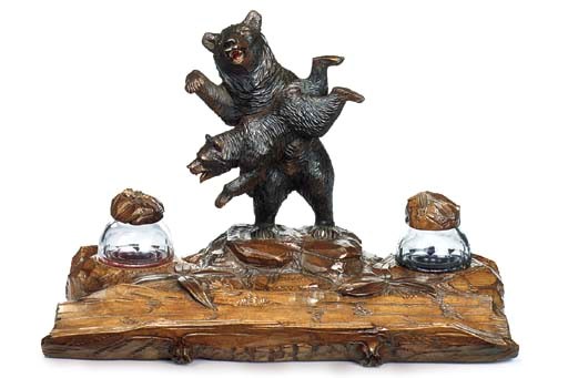 A SWISS 'BLACK FOREST' CARVED WOOD BEAR INKWELL