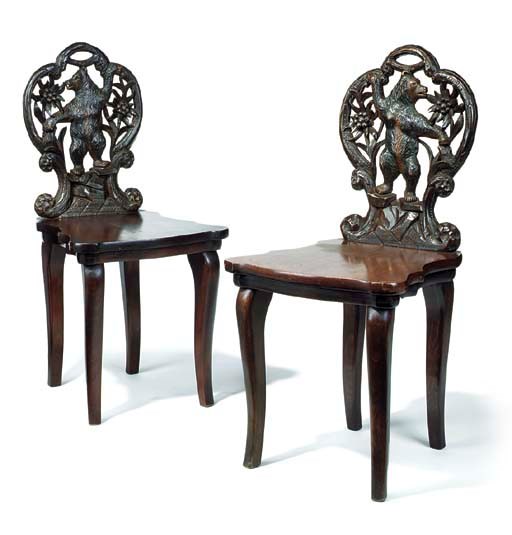 A PAIR OF SWISS 'BLACK FOREST' CARVED WOOD CHILDREN'S CHAIRS