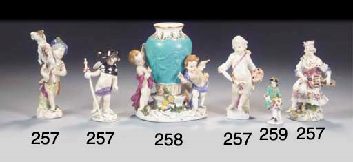 A miniature Meissen porcelain court figure of an aristocrat holding muffs