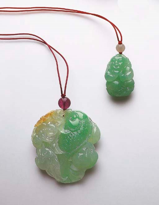 TWO CARVED JADEITE PENDANTS