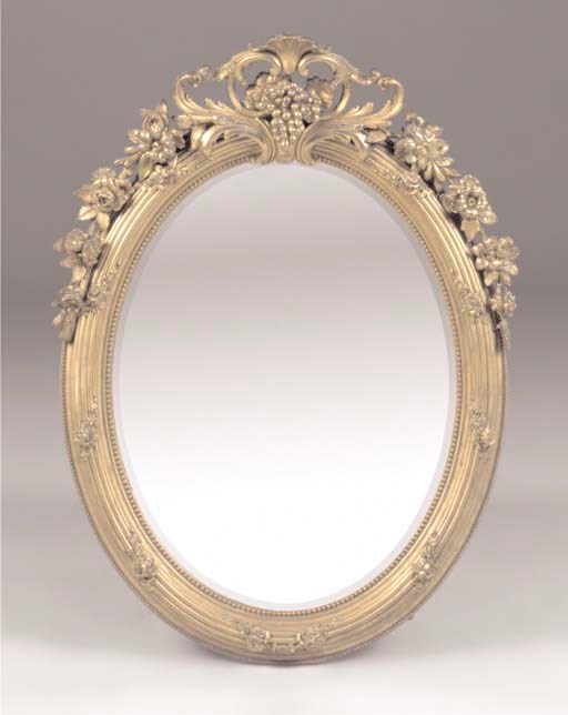 A VICTORIAN GILT COMPOSITION OVAL MIRROR