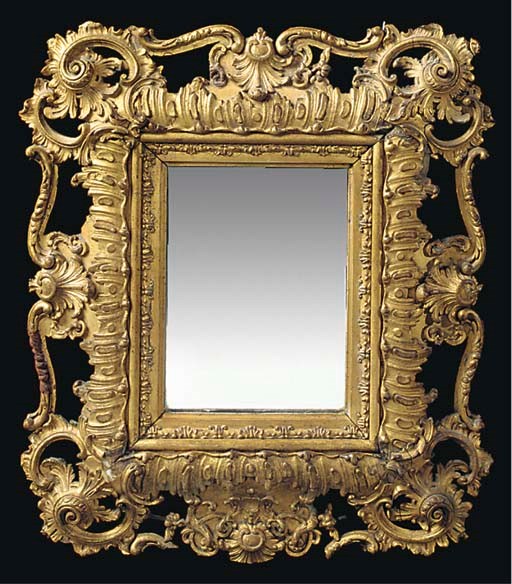 A SMALL ITALIAN CARVED AND GILT COMPOSITION MIRROR