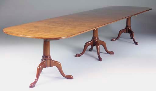A WALNUT TRIPLE PEDESTAL DINING TABLE