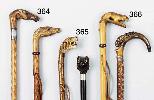 A carved and polychrome painted wood walking stick