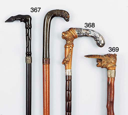 A carved fruitwood and silvered metal mounted gnarled wood walking stick