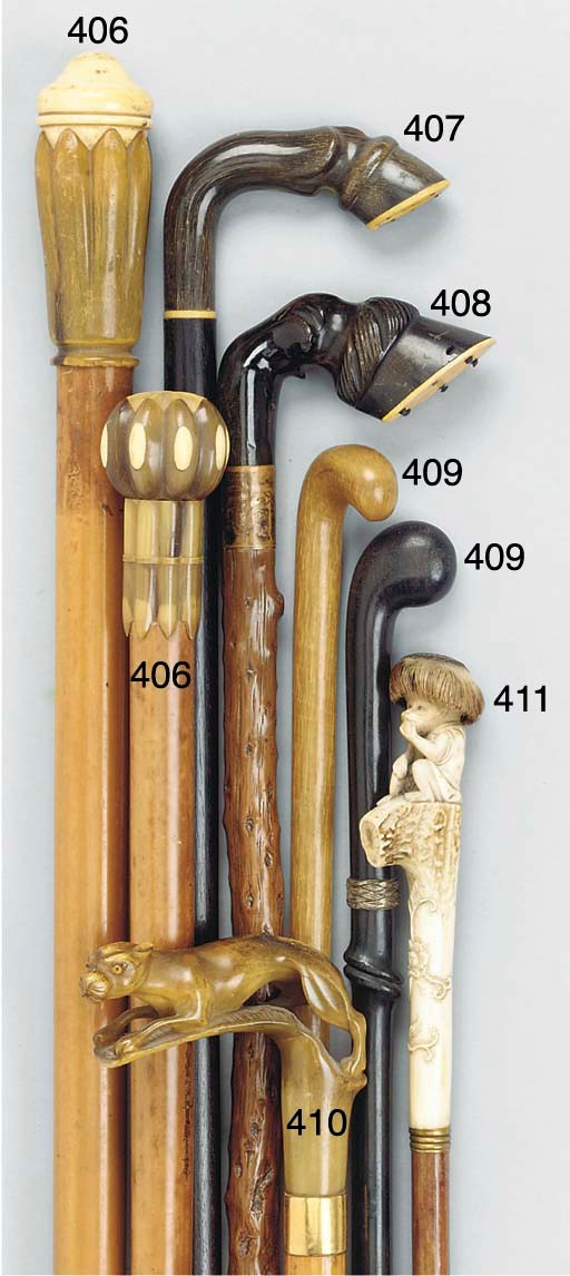 A carved antler mounted bamboo walking stick