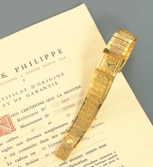 PATEK PHILIPPE. AN UNUSUAL 18K GOLD AND RUBY-SET SQUARE WRISTWATCH WITH BRACELET