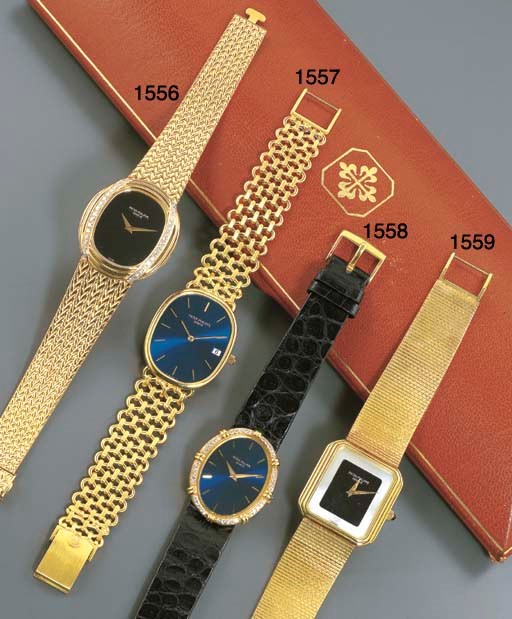 PATEK PHILIPPE. AN 18K GOLD OVAL WRISTWATCH WITH DATE AND BRACELET
