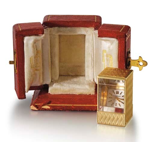 Cartier. A fine and unusual 18K gold rectangular miniature Prism clock