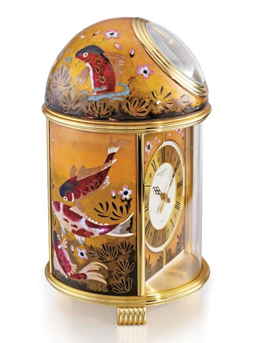 Patek Philippe. A fine and unique gilt brass and enamel solar-powered table clock