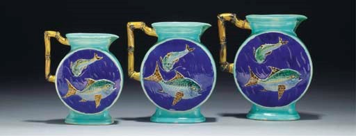 A graduated set of three majolica jugs